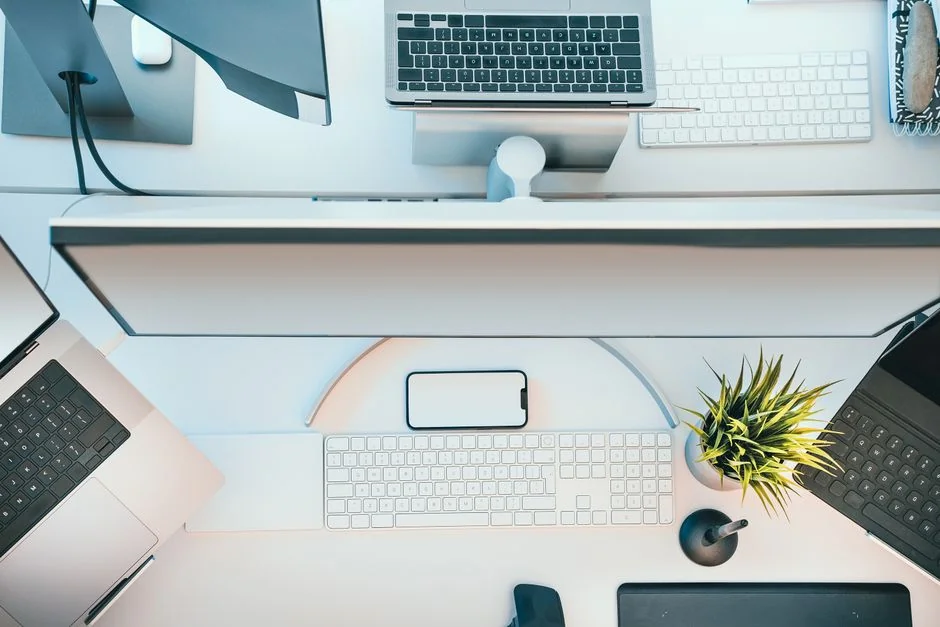 A contemporary office setup with two computer screens showing web design work, highlighting innovation and efficiency.